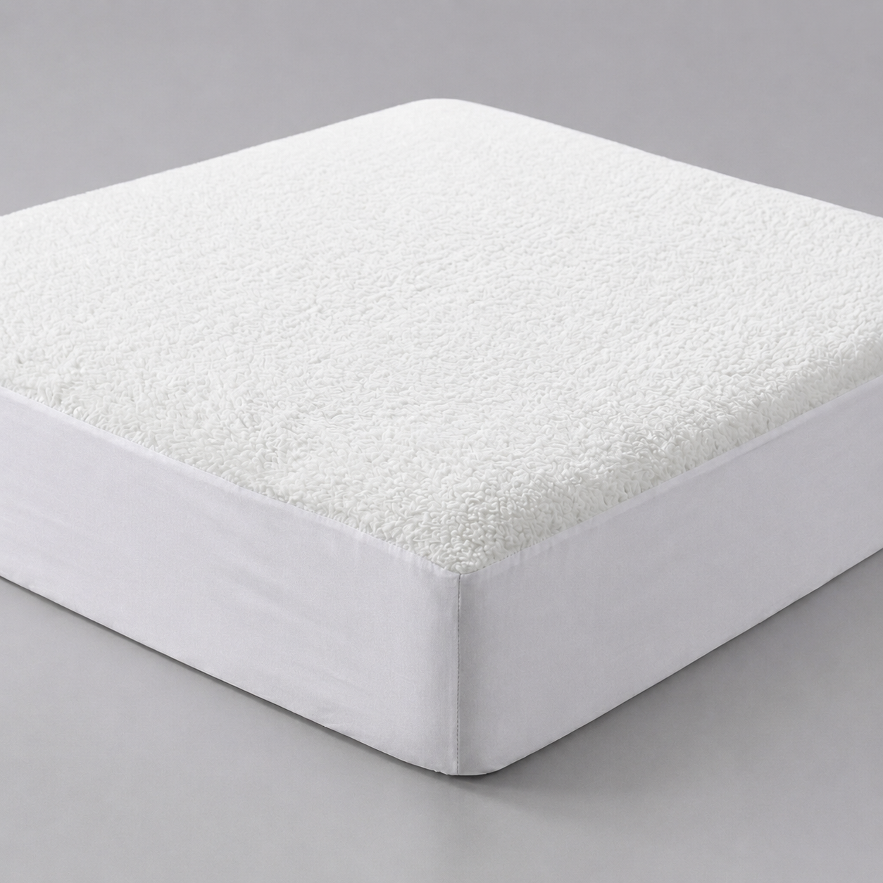 Luxury white thermal fleece underblanket shown as a fully fitted sheet-style mattress protector, with a dense, plush fleece surface wrapping securely and seamlessly around a deep 30cm mattress corner against a seamless grey backdrop.